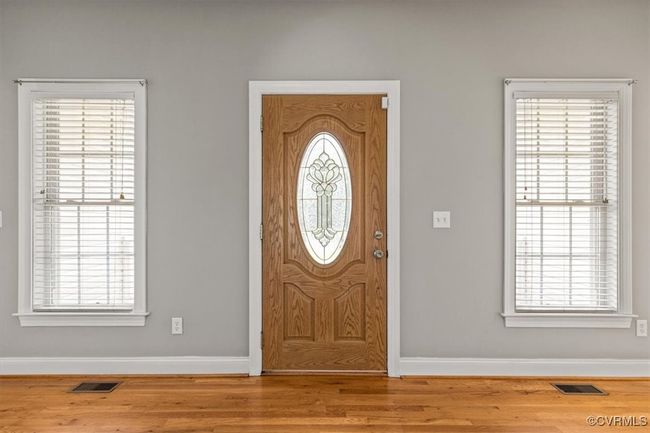Entrance foyer featuring baseboards, wood finished floors, and healthy amount of natural light | Image 6