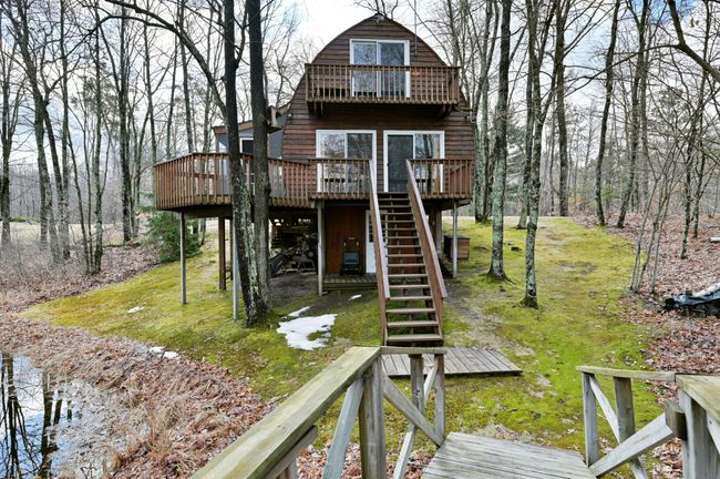 On the other side of the guest cabin is a bridge that goes over the pond. | Image 82