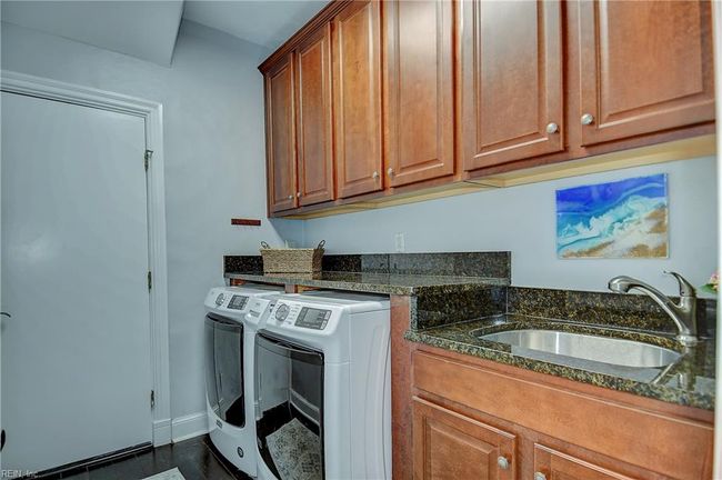 Utility room with sink goes to garage | Image 48