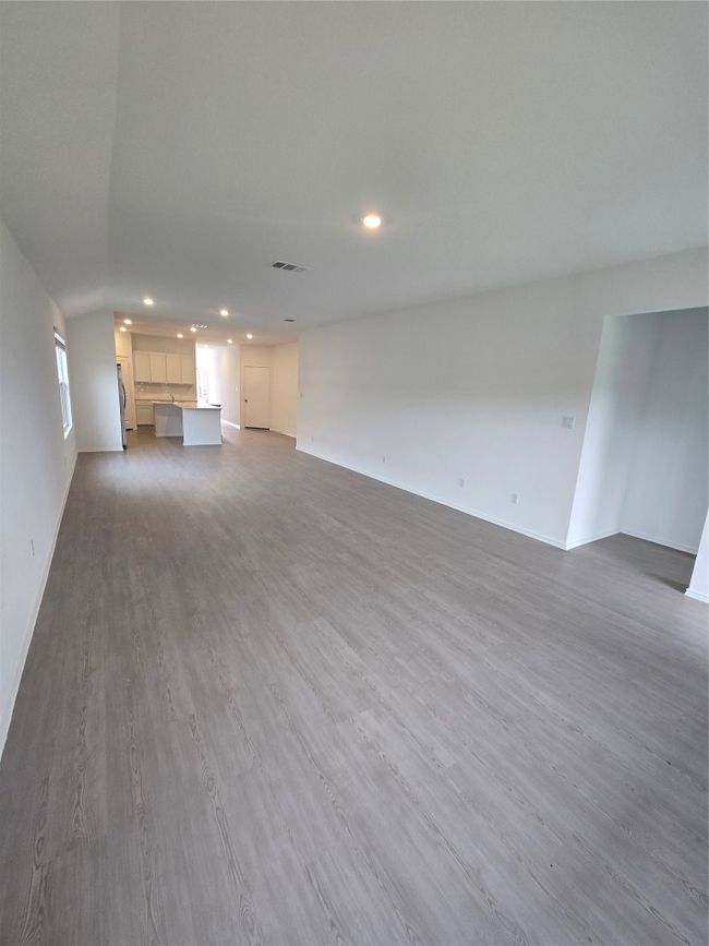 Unfurnished living room featuring recessed lighting and wood finished floors | Image 11