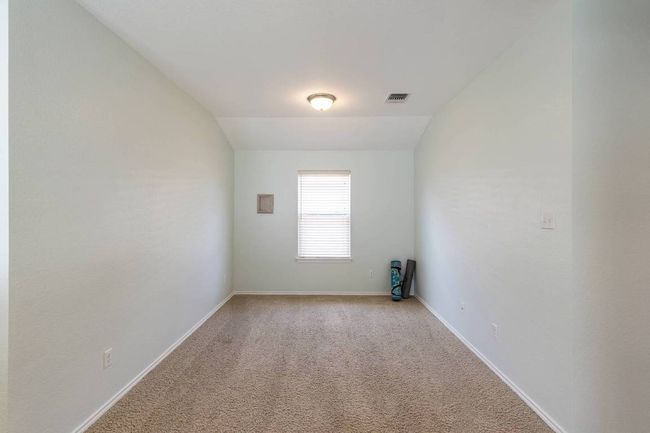 Unfurnished room with light colored carpet and lofted ceiling | Image 11