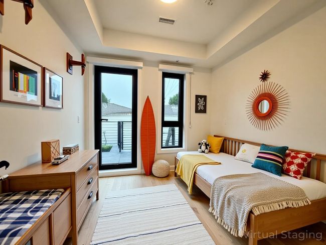 Bedroom featuring light wood finished floors, visible vents, a tray ceiling, and access to exterior | Image 30