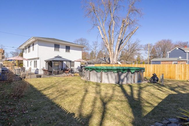 View of yard with beautiful above-ground pool, and fence | Image 20