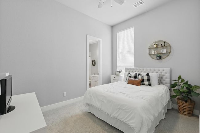 Bedroom with ensuite bathroom and a ceiling fan | Image 19