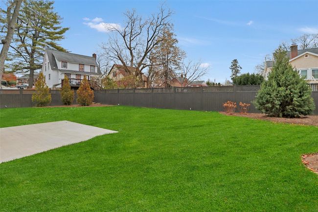 Professionally landscaped yard, with sod lawn, undergraoud sprinkler system and board on board fence. | Image 37