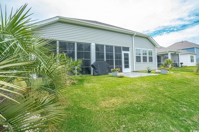 Back of house with a lawn and a patio | Image 5