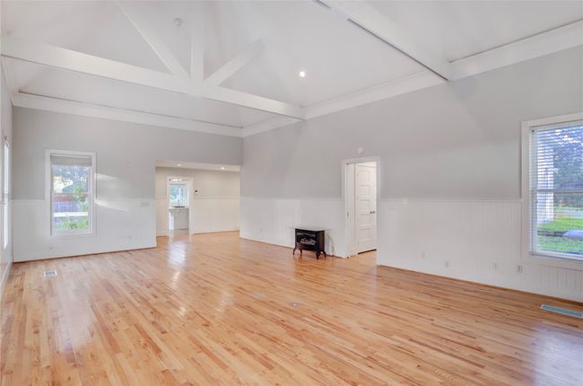 ANOTHER VIEW OF THE HUGE GREAT ROOM WITH A CLEARER PICTURE OF THE LOFTY CATHEDRAL CEILING FEATURING MASSIVE WOOD BEAMS. NOTE THE GAS ROOM HEATER THAT PUTS OUT GREAT HEAT. ALSO, THE A/C IS ONLY 5 YEARS OLD. | Image 18