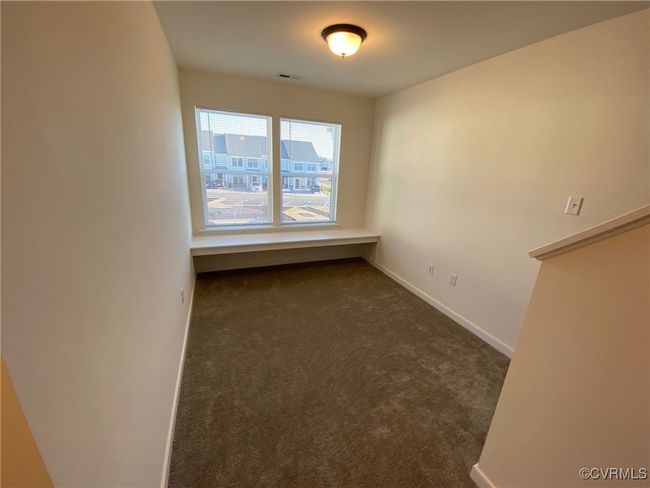 Empty room featuring dark carpet and baseboards | Image 10