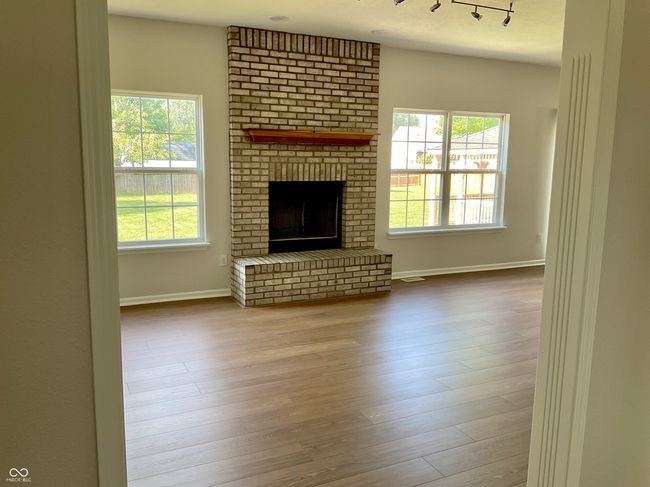 Family room with new flooring (great brick fireplace) | Image 15