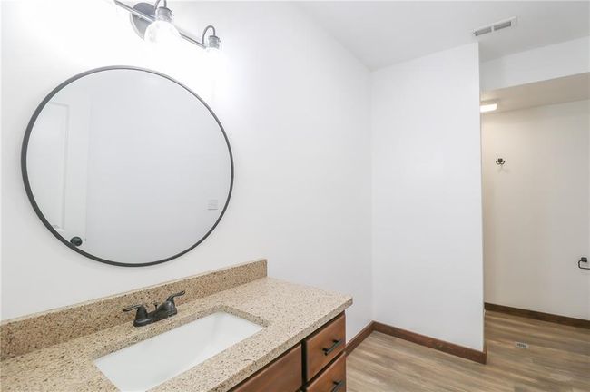 Bathroom with hardwood / wood-style flooring and vanity | Image 43