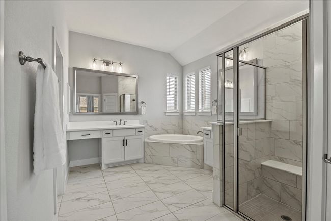 Spa style master bath features his and her vanities with make up area | Image 22