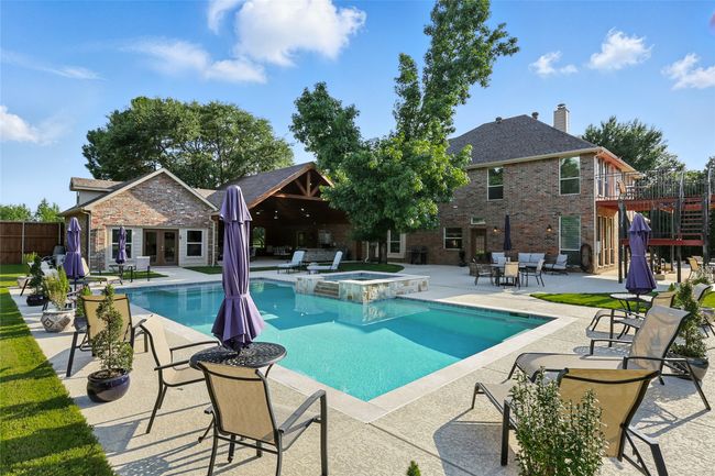View of pool with hot tub, pool house, pavillion and balcony | Image 31