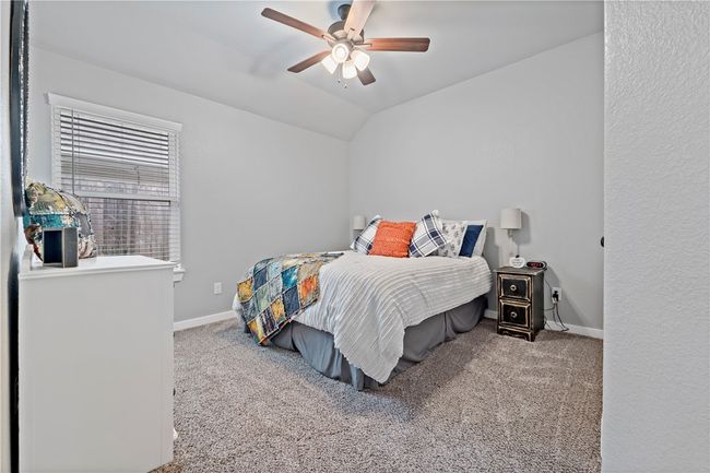 Bedroom featuring baseboards, lofted ceiling, and carpet | Image 8