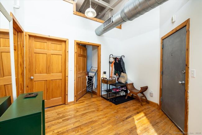 Going through the entry way from the living room and kitchen area towards the bathroom and bedrooms. | Image 10