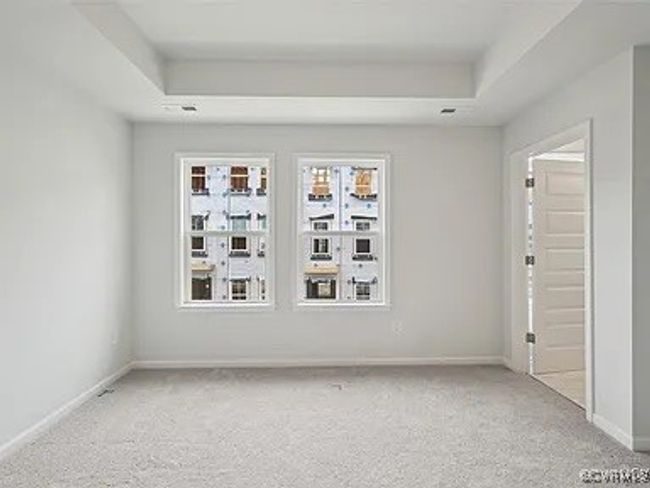 Empty room featuring a raised ceiling and light colored carpet | Image 30