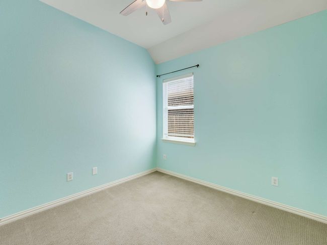Empty room featuring ceiling fan, carpet floors, and lofted ceiling | Image 26