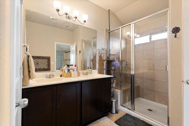 Primary bedroom features ensuite bathroom with double vanity, walk-in showers, linen, and walk-in closets. | Image 32