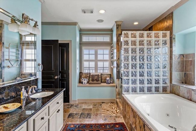 Step into this spacious primary bathroom, where every detail evokes the timeless elegance of Ralph Lauren’s coastal style. Imagine starting each day surrounded by serene hues, natural textures, and refined finishes that echo the beauty of the bay just beyond your window. | Image 30