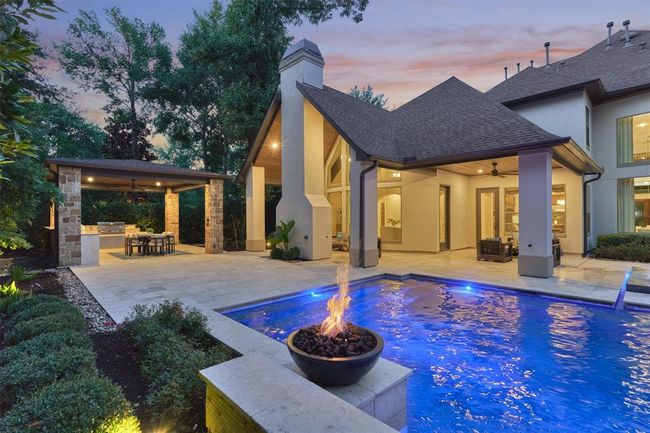 Covered outdoor kitchen, amazing pool/spa with fire bowls, outdoor living area with fireplace, and a sitting area. Plenty of space for everyone! | Image 8