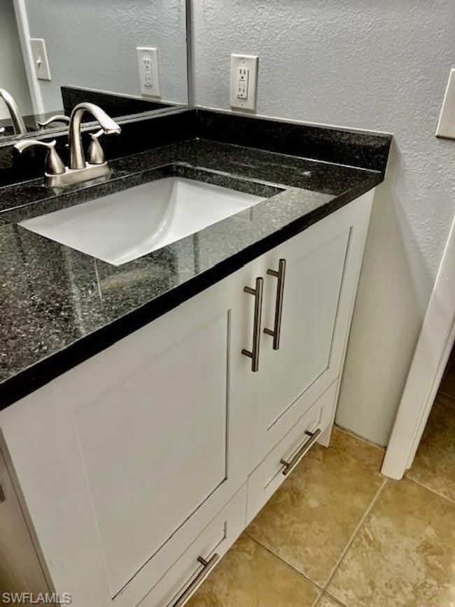 Interior details with a textured wall and vanity | Image 14