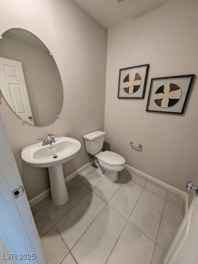 Half bath featuring toilet and tile patterned flooring | Image 17