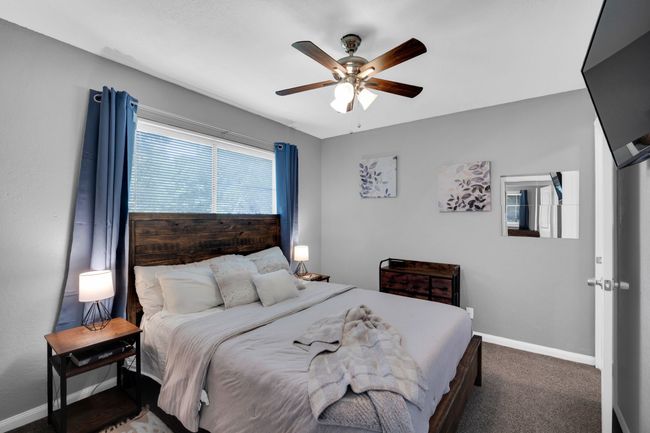 Carpeted bedroom featuring a ceiling fan and baseboards | Image 17