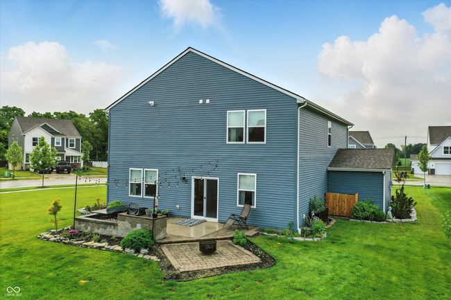 rear view of property featuring a patio area and a yard | Image 40