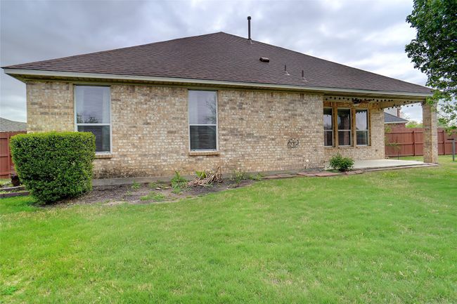 Back of property with fence, a patio, brick siding, roof with shingles, and a yard | Image 26