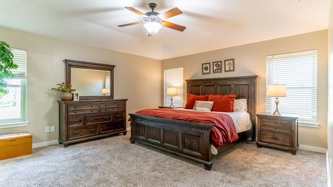 Bedroom with carpet flooring, baseboards, and a ceiling fan | Image 18