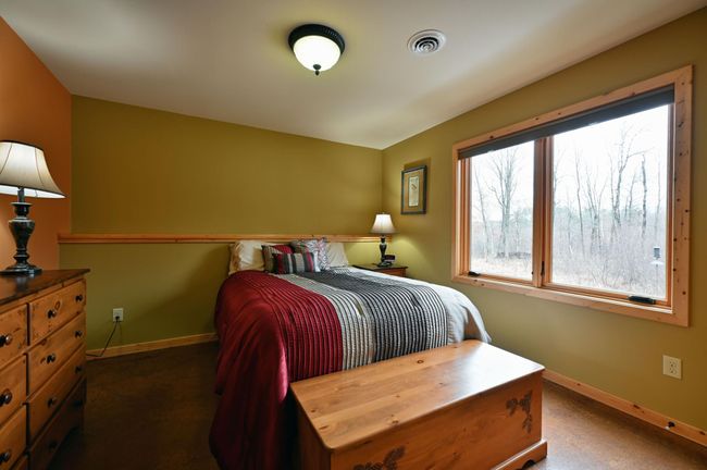 Lower level guest room with a reach-in closet. | Image 48