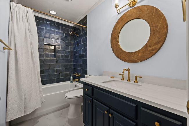 Bathroom featuring vanity, shower / tub combo with curtain, and crown molding | Image 20