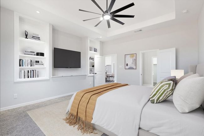 Carpeted bedroom featuring a raised ceiling, ceiling fan, and recessed lighting | Image 7