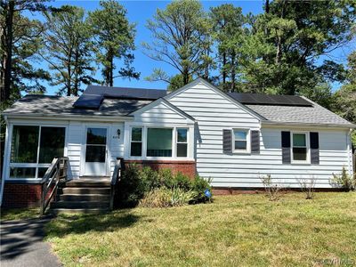 View of front of house featuring solar panels and a front yard | Image 1