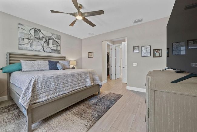 Bedroom featuring visible vents, ceiling fan, baseboards, and light wood-style floors | Image 20