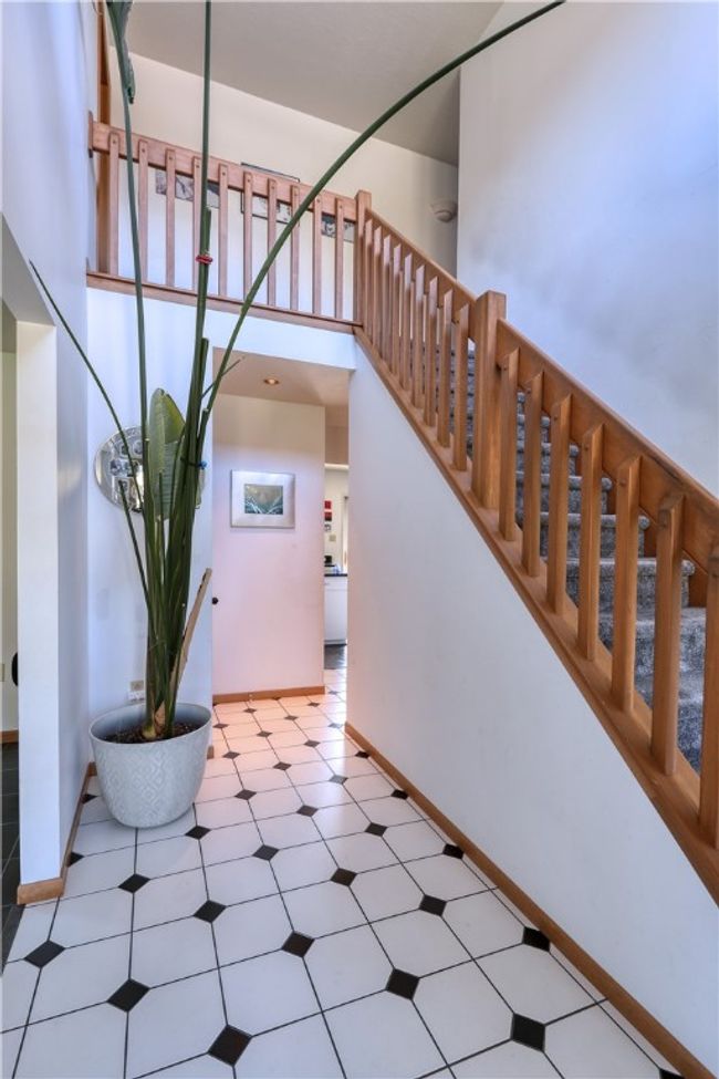 The ceramic tile floor helps to brighten the way into your new home. | Image 4