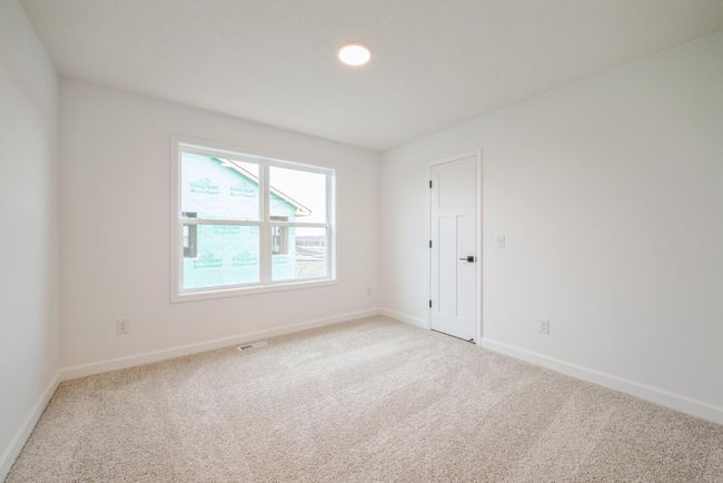 Photo is of the actual home. One of three secondary bedrooms. | Image 13
