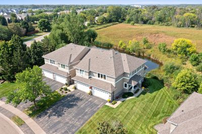 A beautiful end-unit townhome nestled in the heart of Plymouth, featuring serene backyard views of lush greenery and wetlands. | Image 1