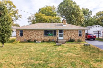 Ranch-style house with a front lawn, an outbuilding, and a garage | Image 3