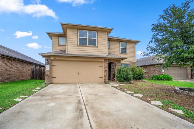 The home has a 2 car attached garage and a long driveway. | Image 44