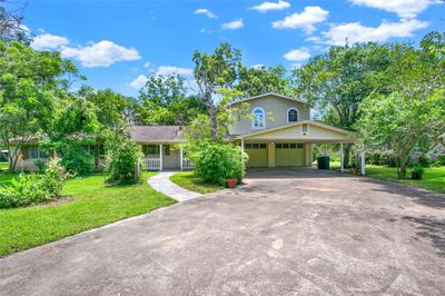 Double-wide driveway with carport and 2 car garage. | Image 2