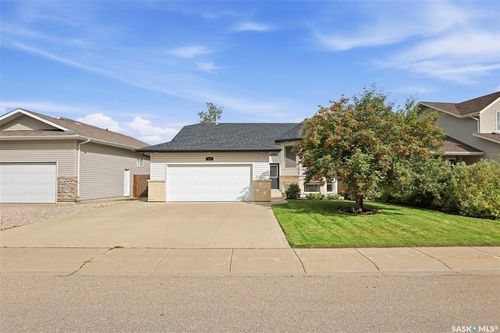 Front exterior with attached double garage, concrete driveway, and a mature landscaping | Card Image
