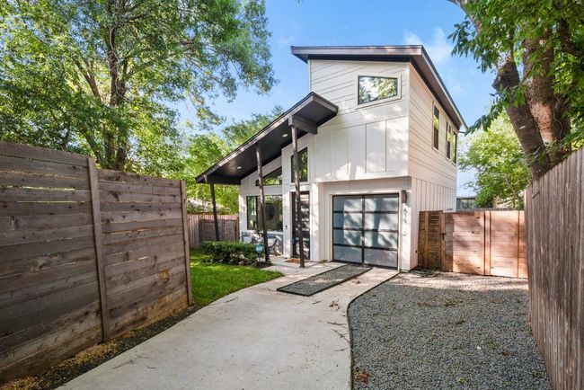 Modern home with driveway, a gate, and an attached garage | Image 4