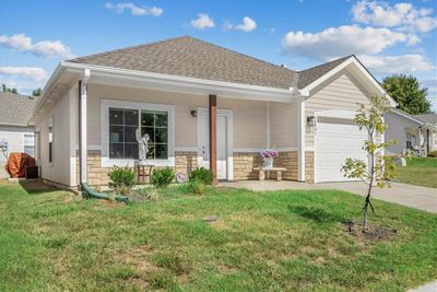 View of front of property with a front yard, a garage, and a porch | Image 3