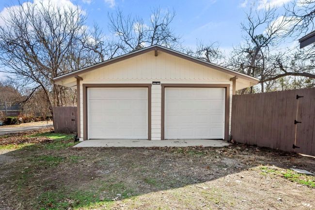Detached garage featuring fence | Image 4
