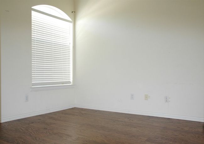 Unfurnished room with wood finished floors and baseboards | Image 8