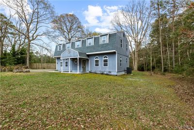 View of front of home with central AC unit and a front lawn | Image 3