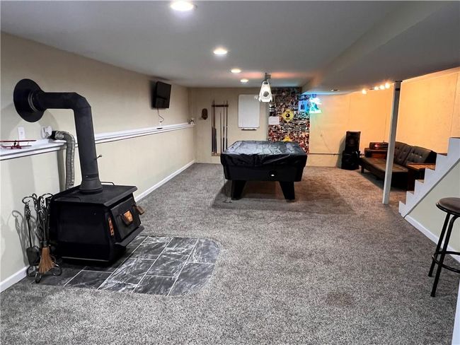 Rec room featuring carpet, a wood stove, billiards table, and recessed lighting | Image 24