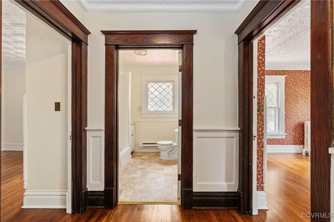 Hallway with wood floors, plenty of natural light, and wallpapered walls | Image 26