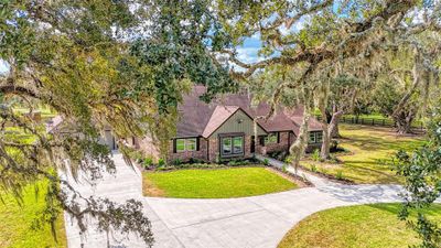 A newly poured circular concrete drive way and 2 car width wide garage entry are appropriate introductions to this picturesque property. | Image 2