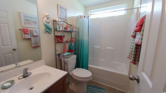 Bathroom featuring vanity, shower / bath combo, and tile patterned flooring | Image 11
